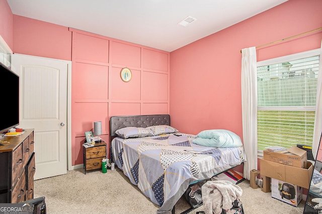 bedroom featuring light colored carpet