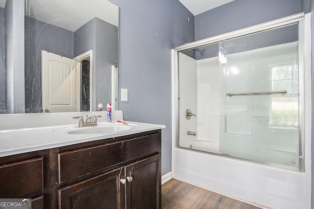 bathroom with shower / bath combination with glass door, vanity, and hardwood / wood-style flooring