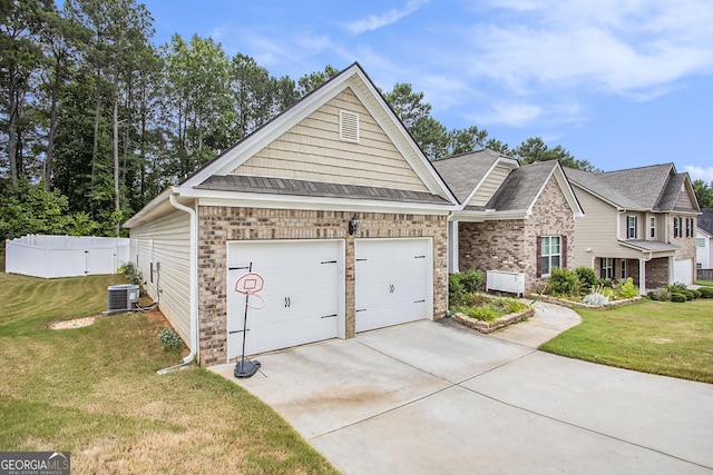 view of front of property featuring central air condition unit, a front lawn, and a garage