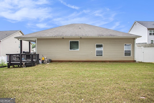 back of house with a yard and a wooden deck