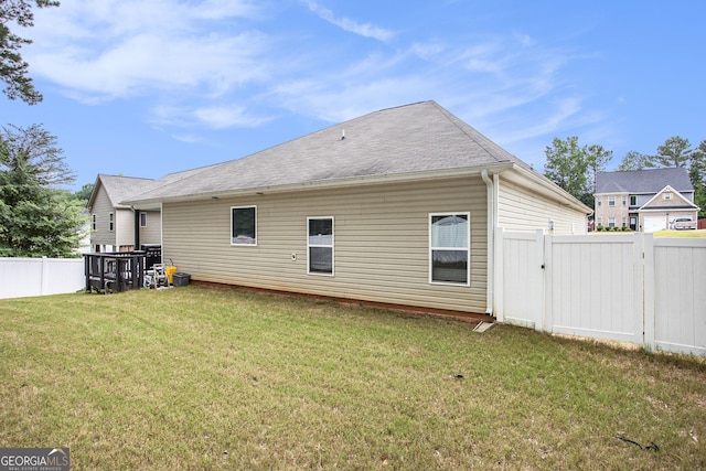 rear view of property with a lawn