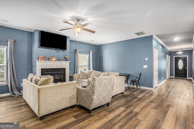 living room with ceiling fan and dark wood-type flooring