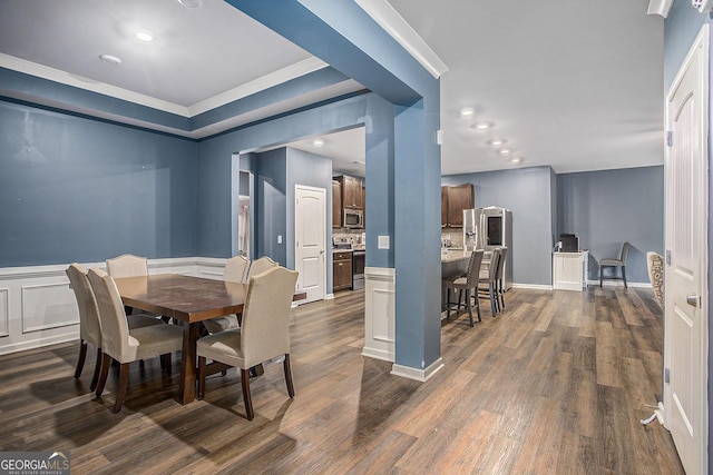 dining room with crown molding and dark wood-type flooring