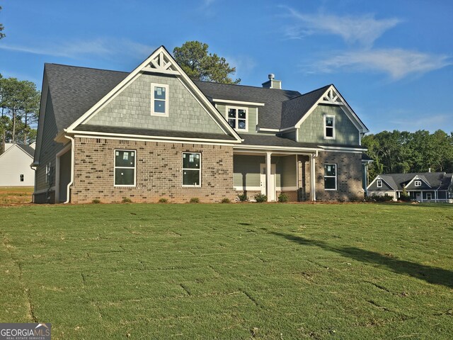 back of house with a lawn