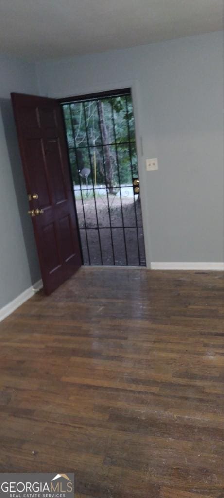 empty room with dark wood-type flooring