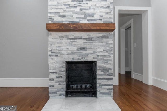 details with a fireplace and wood finished floors