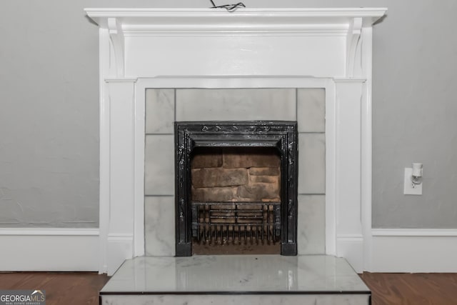 interior details with a fireplace and wood finished floors