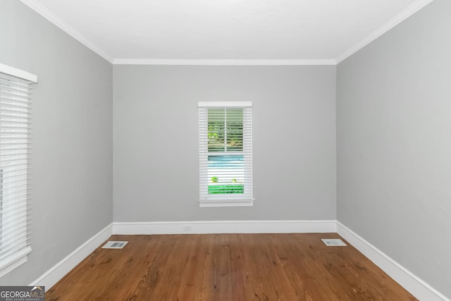 unfurnished room featuring crown molding, visible vents, and baseboards