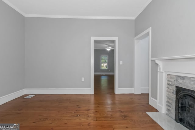 unfurnished living room with ornamental molding, a fireplace, wood finished floors, and baseboards