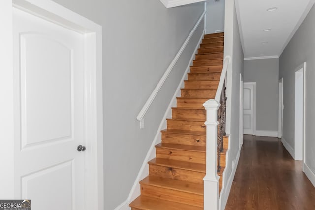 stairway featuring wood finished floors and baseboards