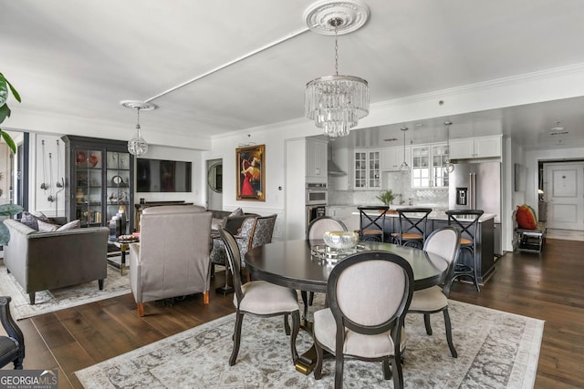 dining room with a notable chandelier, crown molding, and dark wood-style flooring