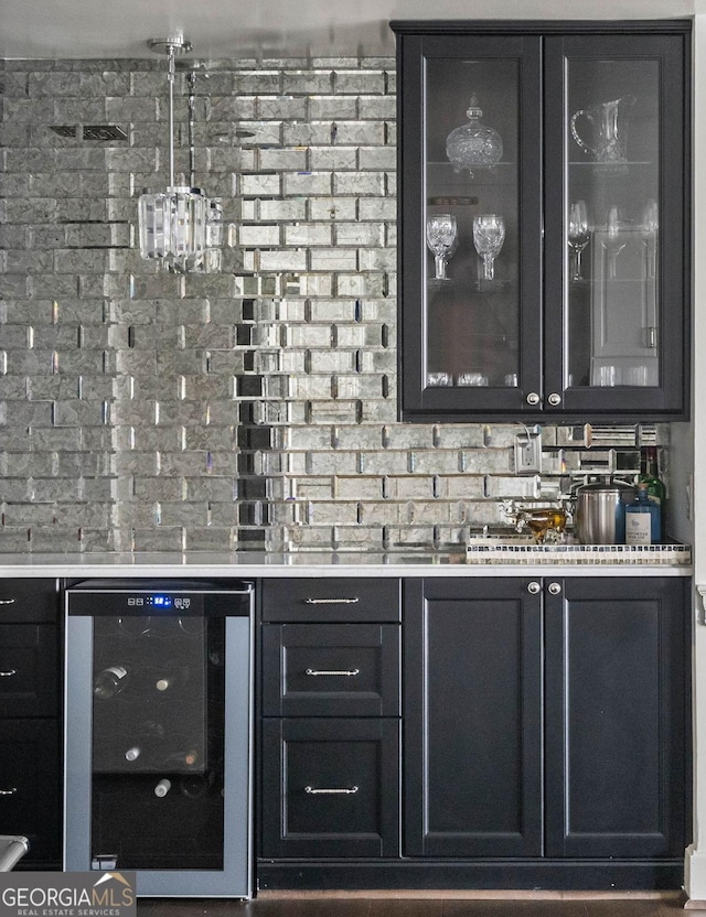 bar with wet bar, beverage cooler, and brick wall