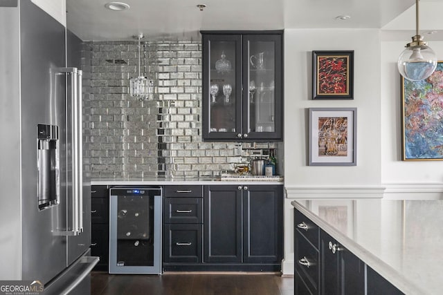 bar featuring beverage cooler, pendant lighting, dark wood-style flooring, bar area, and high end fridge