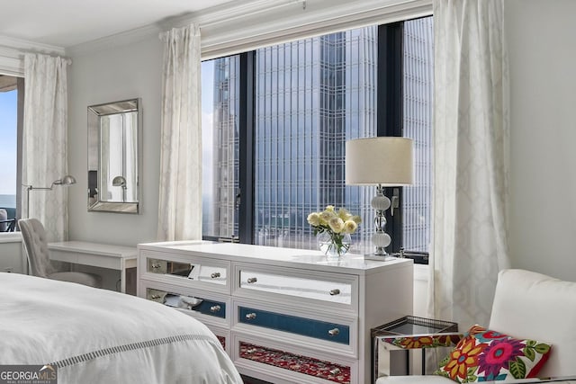 bedroom with ornamental molding and multiple windows