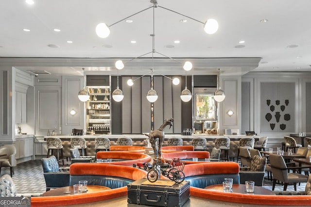 interior space with ornamental molding, a decorative wall, and recessed lighting