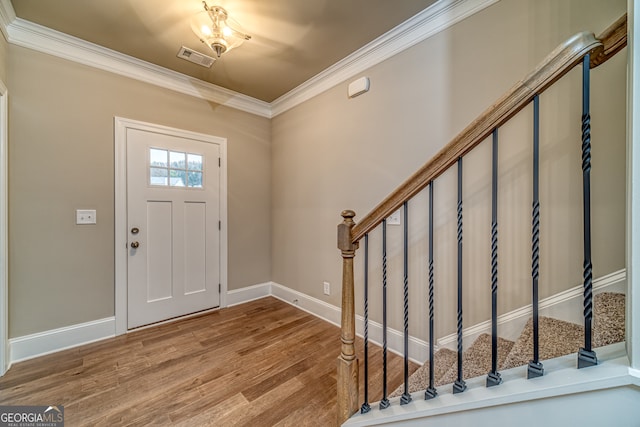 entryway with crown molding and hardwood / wood-style flooring