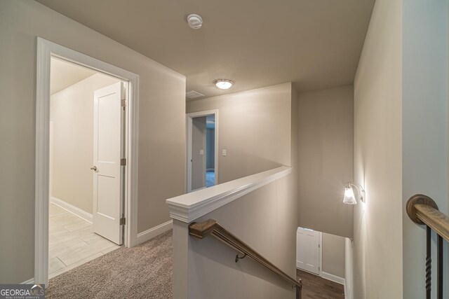 hallway featuring light carpet