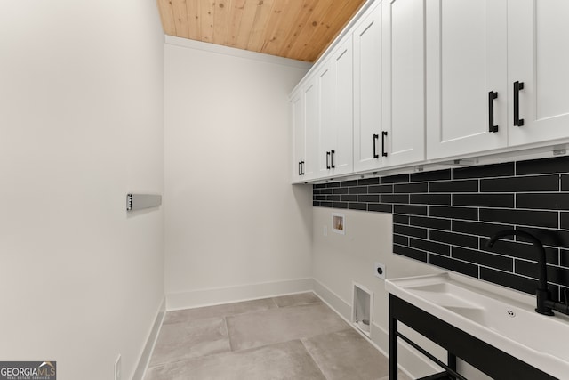 clothes washing area featuring cabinets, electric dryer hookup, hookup for a washing machine, sink, and wooden ceiling