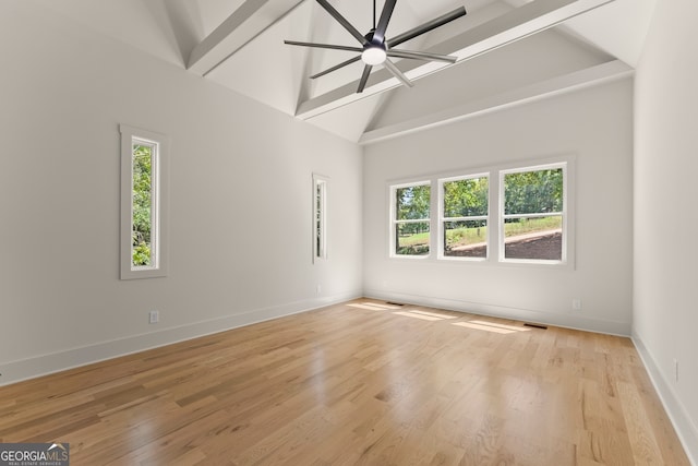 unfurnished room with ceiling fan, high vaulted ceiling, beam ceiling, and light hardwood / wood-style floors