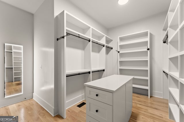 spacious closet featuring light wood-type flooring