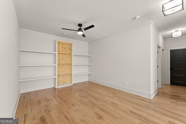 interior space featuring wood-type flooring, ceiling fan, and ornamental molding