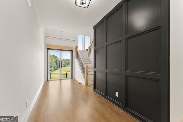 hallway with light hardwood / wood-style floors