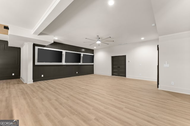 unfurnished living room with light wood-type flooring, ceiling fan, and crown molding