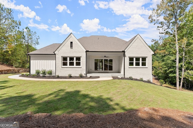 rear view of property with a lawn and a patio area