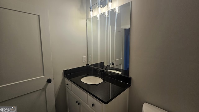 bathroom featuring vanity and toilet