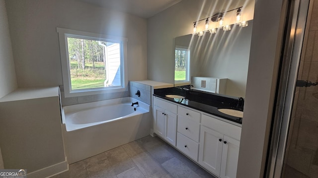 bathroom with vanity and a bath