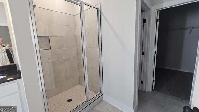 bathroom with vanity, tile patterned floors, and a shower with shower door