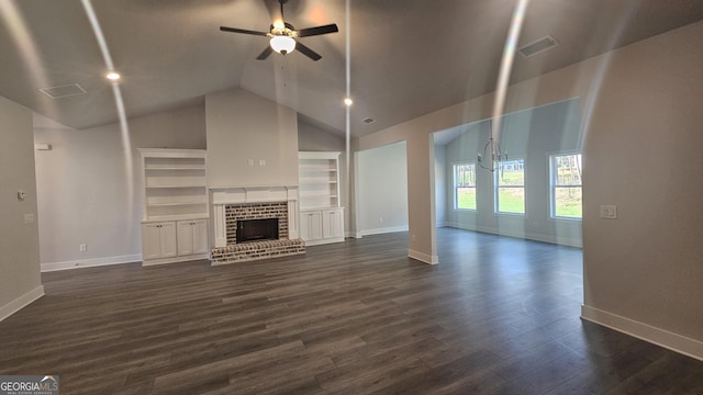 unfurnished living room with ceiling fan with notable chandelier, a fireplace, lofted ceiling, and dark wood-type flooring