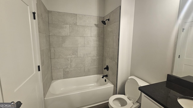 full bathroom with vanity, tiled shower / bath combo, and toilet