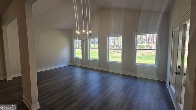 unfurnished dining area with an inviting chandelier, dark hardwood / wood-style flooring, and vaulted ceiling