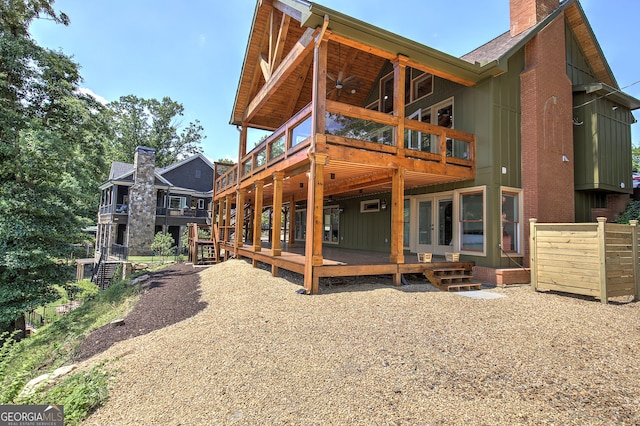 back of property featuring a wooden deck and ceiling fan