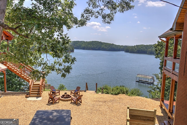 property view of water featuring an outdoor fire pit