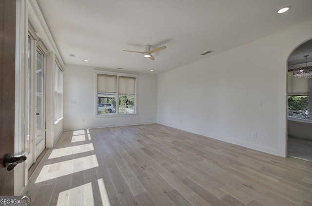 empty room with light hardwood / wood-style flooring and ceiling fan