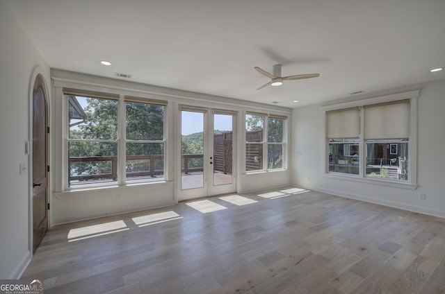 unfurnished room with french doors, ceiling fan, and light hardwood / wood-style flooring