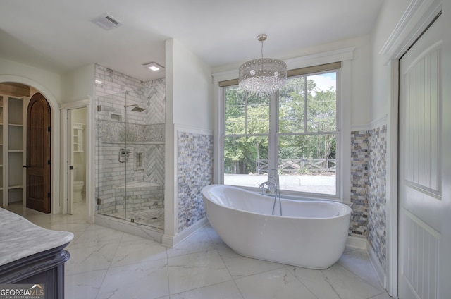 full bathroom featuring independent shower and bath, vanity, tile walls, and toilet