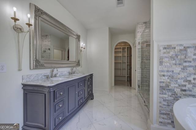 bathroom featuring vanity and a shower with shower door