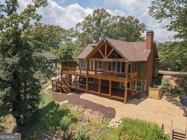 rear view of property featuring a deck