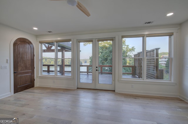 entryway with a wealth of natural light, ceiling fan, and light hardwood / wood-style flooring