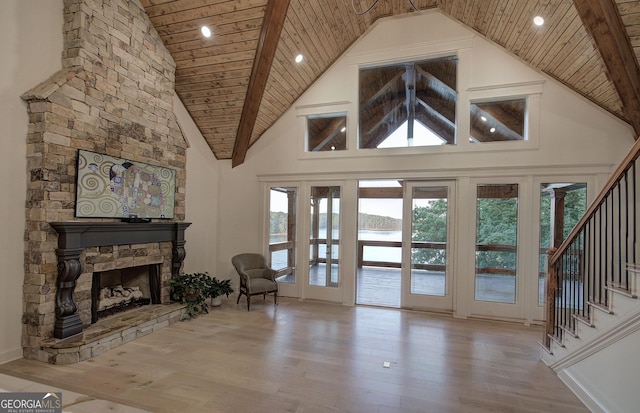 living room with wood ceiling, a fireplace, high vaulted ceiling, and wood-type flooring