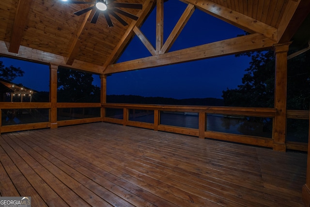 deck at twilight featuring ceiling fan