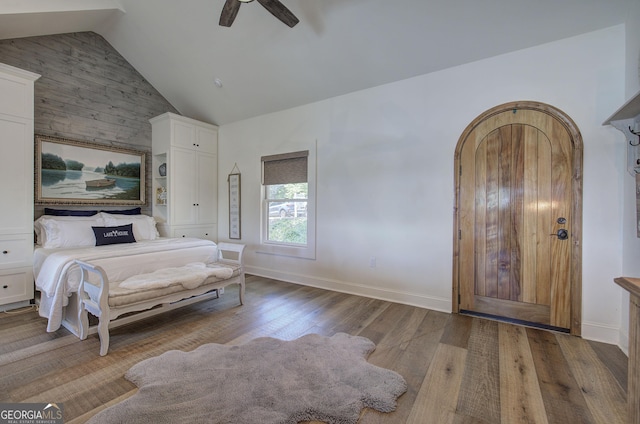 bedroom with vaulted ceiling, hardwood / wood-style floors, and ceiling fan