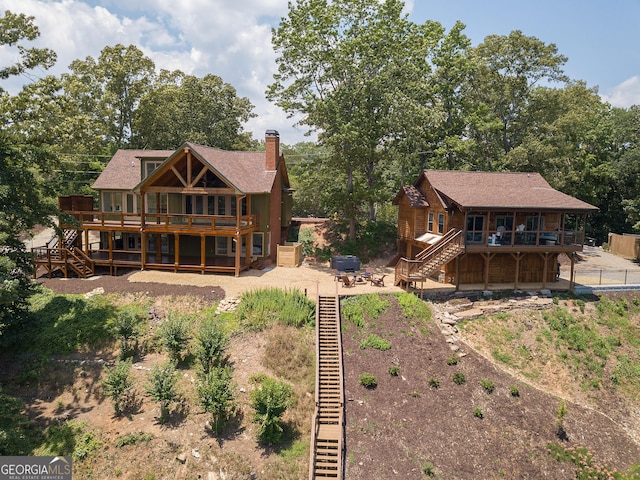 rear view of property featuring a deck and a patio