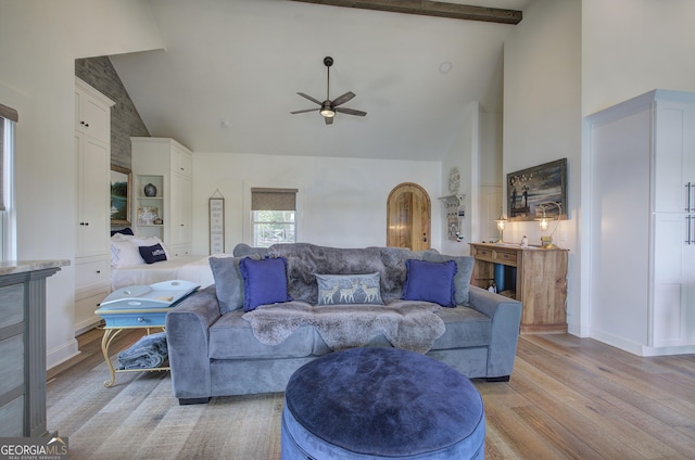 living room with ceiling fan, high vaulted ceiling, and light wood-type flooring