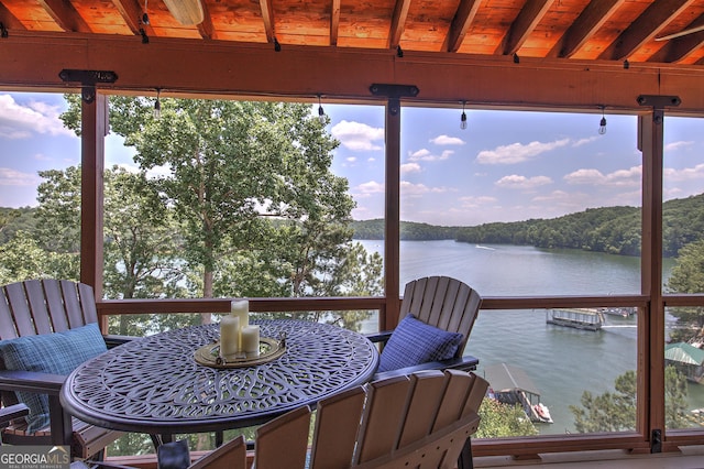 wooden terrace featuring a water view