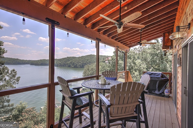 deck featuring a water view, ceiling fan, and grilling area