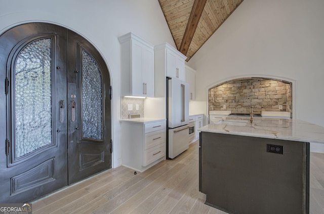 entrance foyer with high vaulted ceiling, beamed ceiling, french doors, wooden ceiling, and light hardwood / wood-style flooring